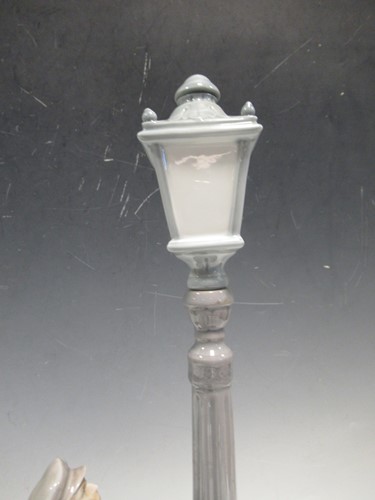 Lot 78 - A Lladro figure of a lamplighter 46cm high and...