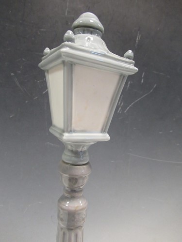Lot 78 - A Lladro figure of a lamplighter 46cm high and...