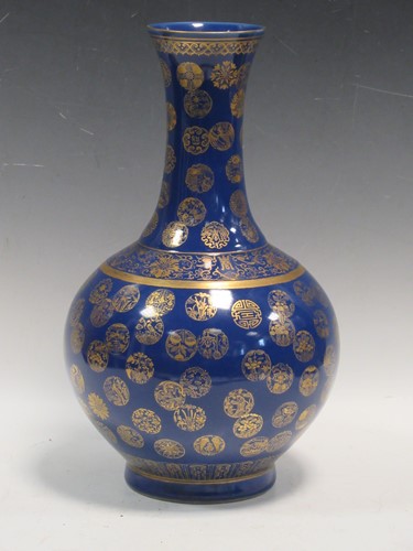 Lot 39 - A Chinese bottle vase, the blue ground body...