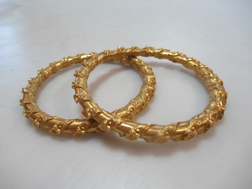 Lot 186 - Two Asain wax filled childrens bangles, inside...