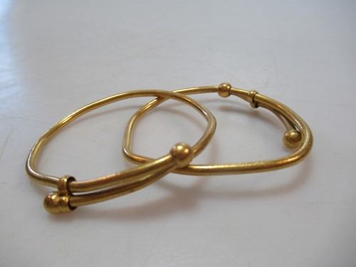 Lot 187 - Two misshapen childrens bangles, tested as...