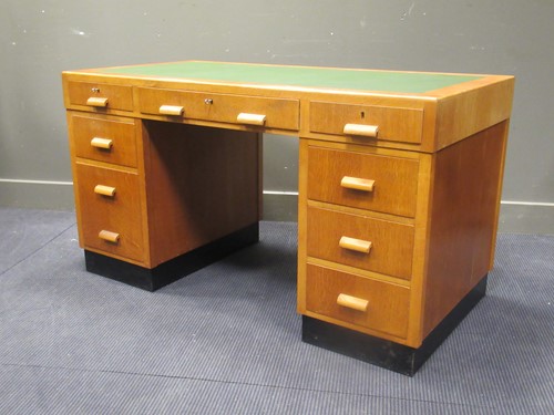 Lot 514 - A light oak veneered twin pedestal desk of...