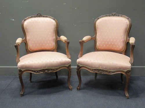 Lot 568 - A pair of Louis XV style carved walnut...