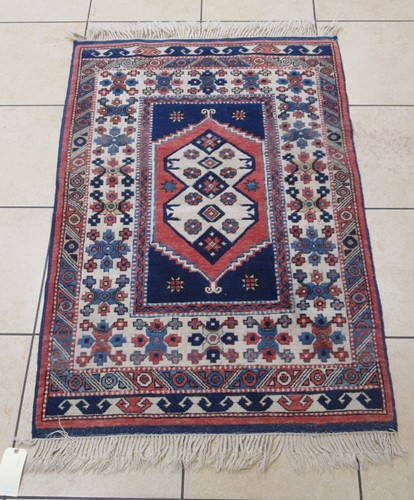 Lot 591 - A attractive Caucasian style rug in ivory, indigo and madder palette