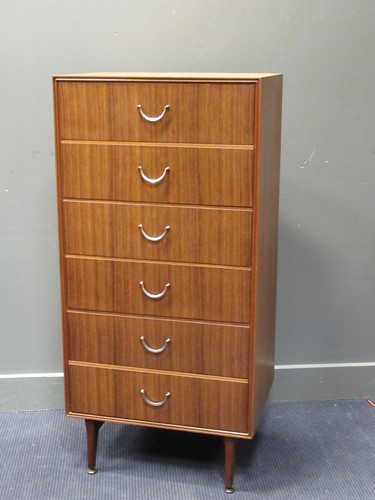Lot 574 - A modern narrow chest of six drawers raised on...