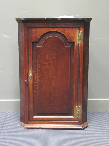 Lot 450 - A Georgian oak corner cupboard with single...