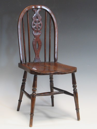 Lot 47 - An oak child's chair with pierced wheel splat,...