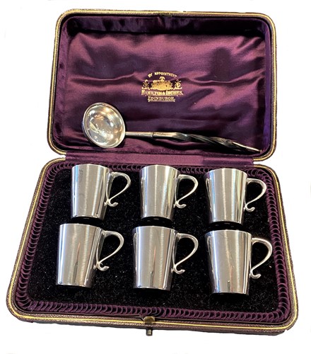 Lot 374 - Edinburgh - A cased set of six silver tot cups together with a silver toddy ladle