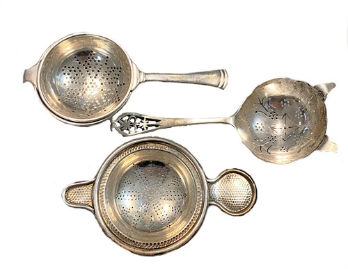 Lot 395 - A trio of 20th century silver tea strainers