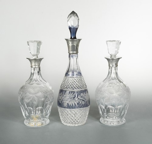 Lot 587 - A trio (a pair and a singleton) of 20th century cut glass decanters with silver collars