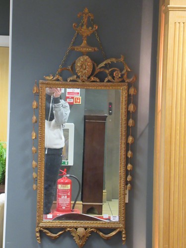 Lot 601 - A rectangular gilt wall mirror with decorative...