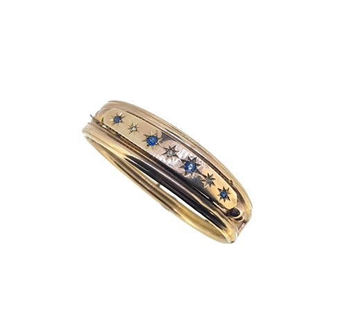 Lot 110 - A late Victorian sapphire and diamond bangle