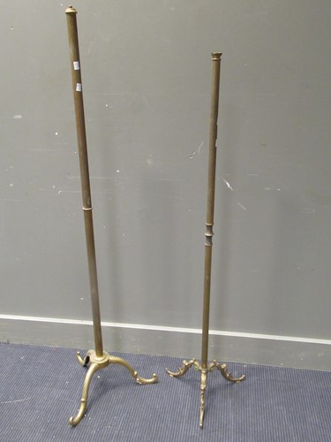 Lot 545 - Two brass standard lamps on tripod legs,...