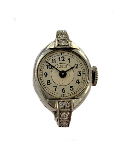 Lot 319 - Aris - A French platinum and diamond set ring watch