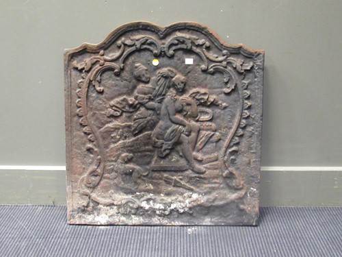 Lot 665 - A cast iron fire back of arched form depicting...
