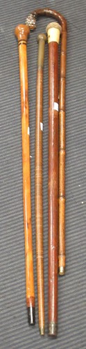 Lot 179 - A 19th century ivory topped walking cane, a...