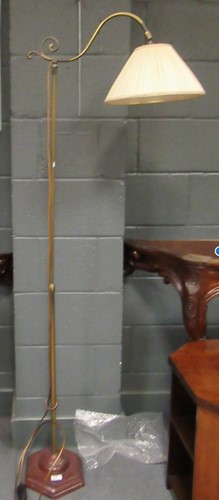 Lot 647 - A brass floor lamp on a wooden plinth, 167cm