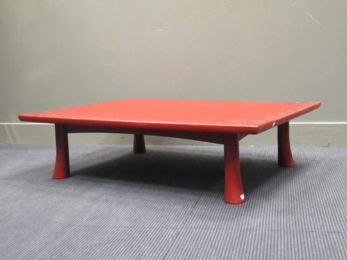 Lot 498 - An Asian pale red low table with leaf moulded...