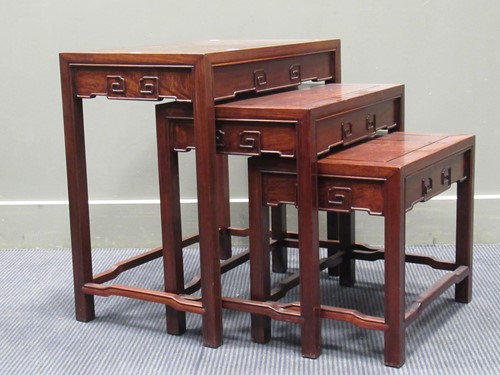 Lot 642 - A nest of three modern Chinese hardwood tables,...