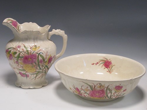 Lot 146 - A floral decorated jug and wash bowl