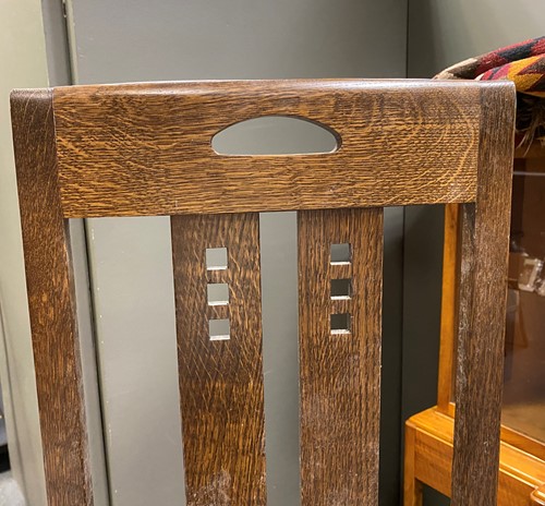 Lot 175 - In the manner of Charles Rennie Mackintosh, a modern oak dining table and four chairs