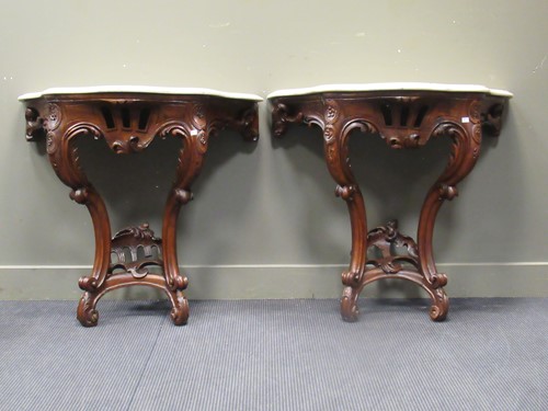 Lot 626 - A pair of Louis XV style carved walnut console...