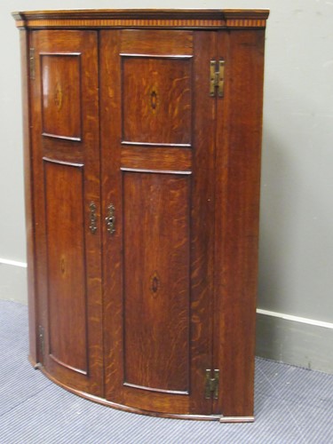 Lot 635 - A Georgian oak and inlaid bow fronted hanging...
