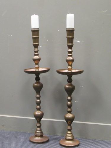 Lot 548 - A pair of brass floor standing candlestands...