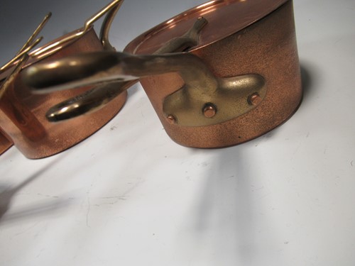 Lot 171 - A set of four copper saucepans and lids with...