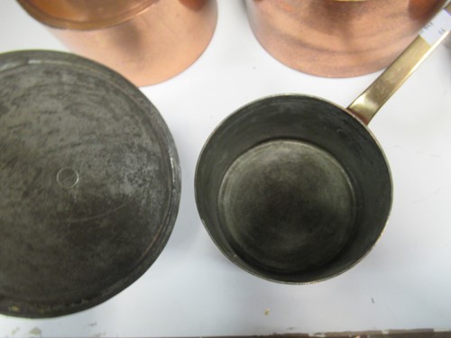 Lot 171 - A set of four copper saucepans and lids with...