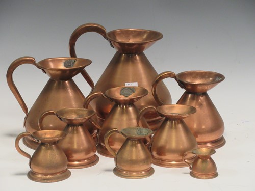 Lot 109 - A matched set of nine graduated copper jugs,...