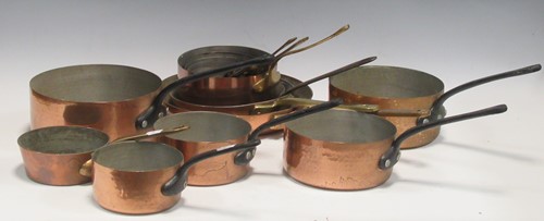 Lot 116 - A set of five copper saucepans with cast iron...