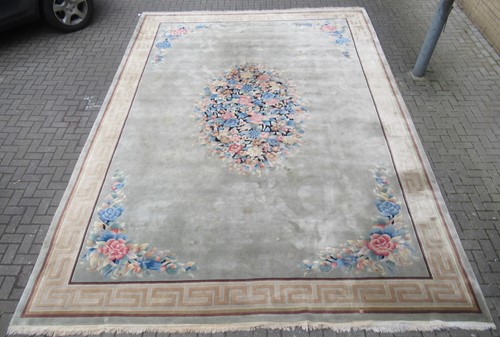 Lot 709 - A large Chinese carpet, decorated with central...