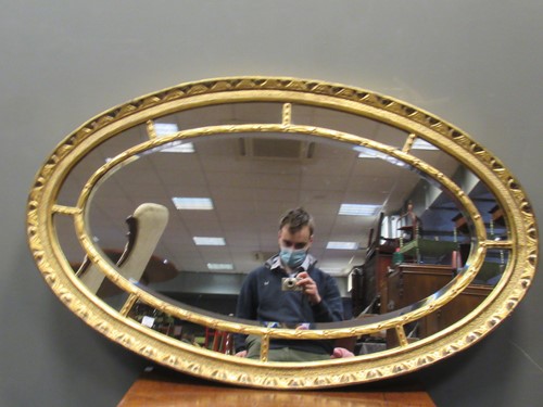 Lot 537 - A 19th century oval sectional wall mirror, the...