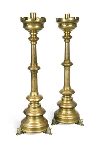 Lot 203 - A pair of brass ecclesiastical candle stands