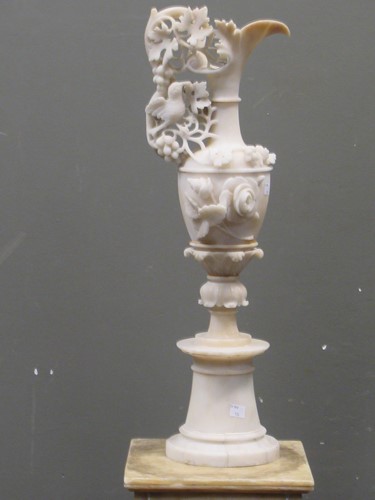 Lot 54 - A carved alabaster urn with fruiting vine and...