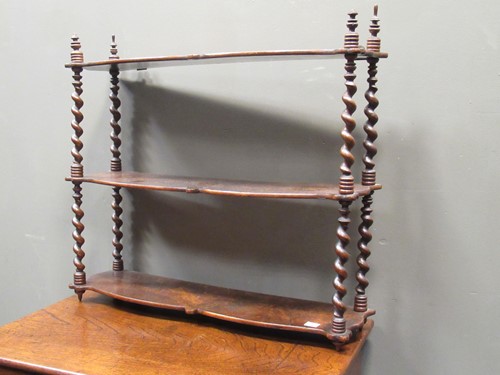 Lot 462 - A Victorian walnut three tier wall shelf with...