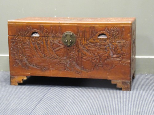 Lot 637 - A modern Chinese camphorwood chest with carved...