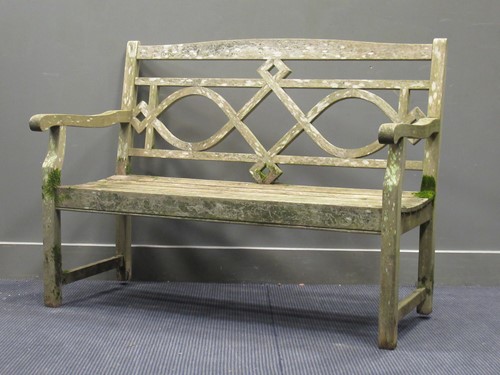 Lot 702 - A wooden garden bench with interlaced back...