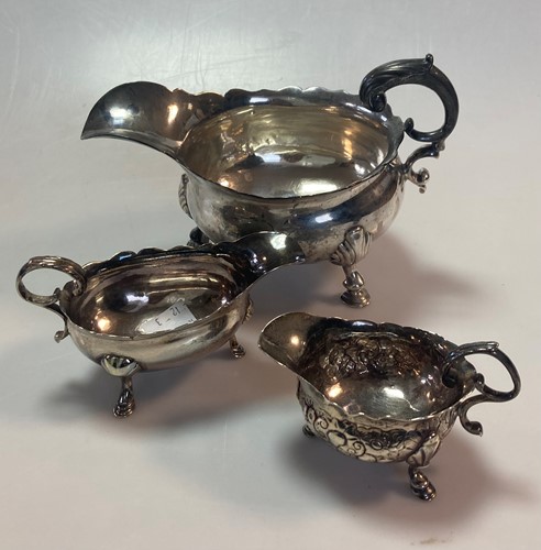 Lot 243 - Three mid 18th century silver sauceboats,...