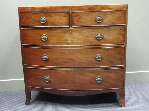 Lot 491 - A Regency mahogany bow front chest of two...