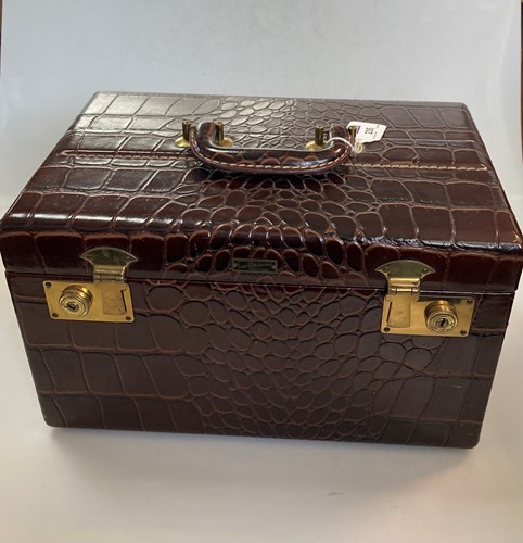 Lot 235 - A crocodile skin jewellery case with label for...