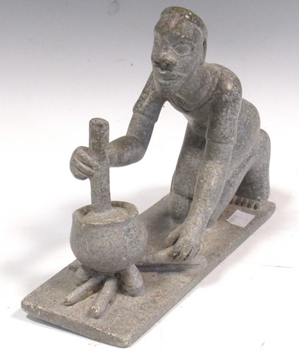 Lot 18 - An African grey soft stone carving of a man kneeling, 20th century