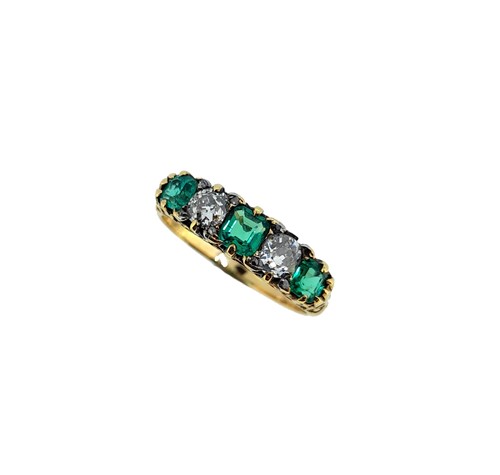 Lot 211 - An emerald and diamond carved half hoop style ring