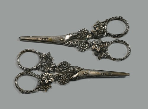 Lot 553 - Two matching pairs of George V silver grape scissors