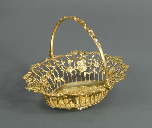 Lot 488 - An early George III silver gilt swing handled bon bon basket