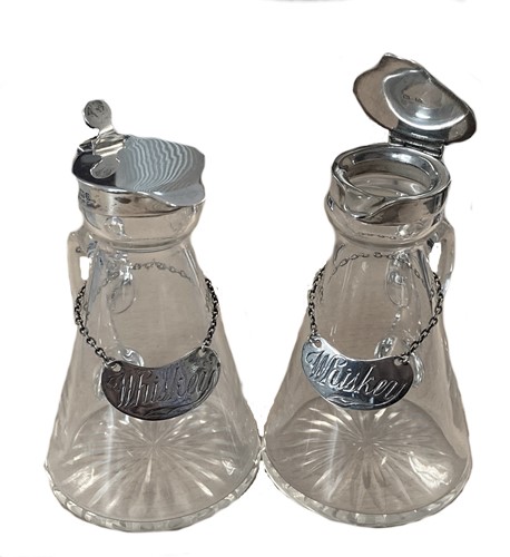 Lot 376 - A matching pair of early 20th century silver and glass whisky noggins