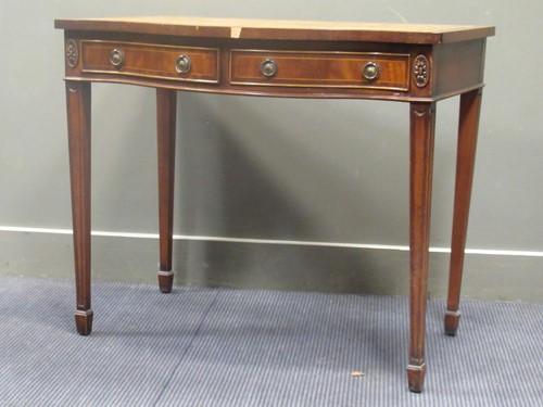 Lot 693 - An Edwardian mahogany serpentine writing table...