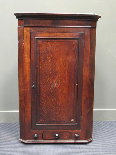 Lot 681 - A Georgian oak and mahogany corner cupboard...