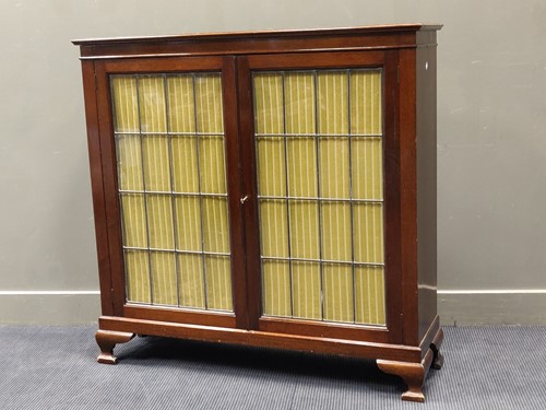 Lot 707 - A mahogany two door side cabinet with leaded...